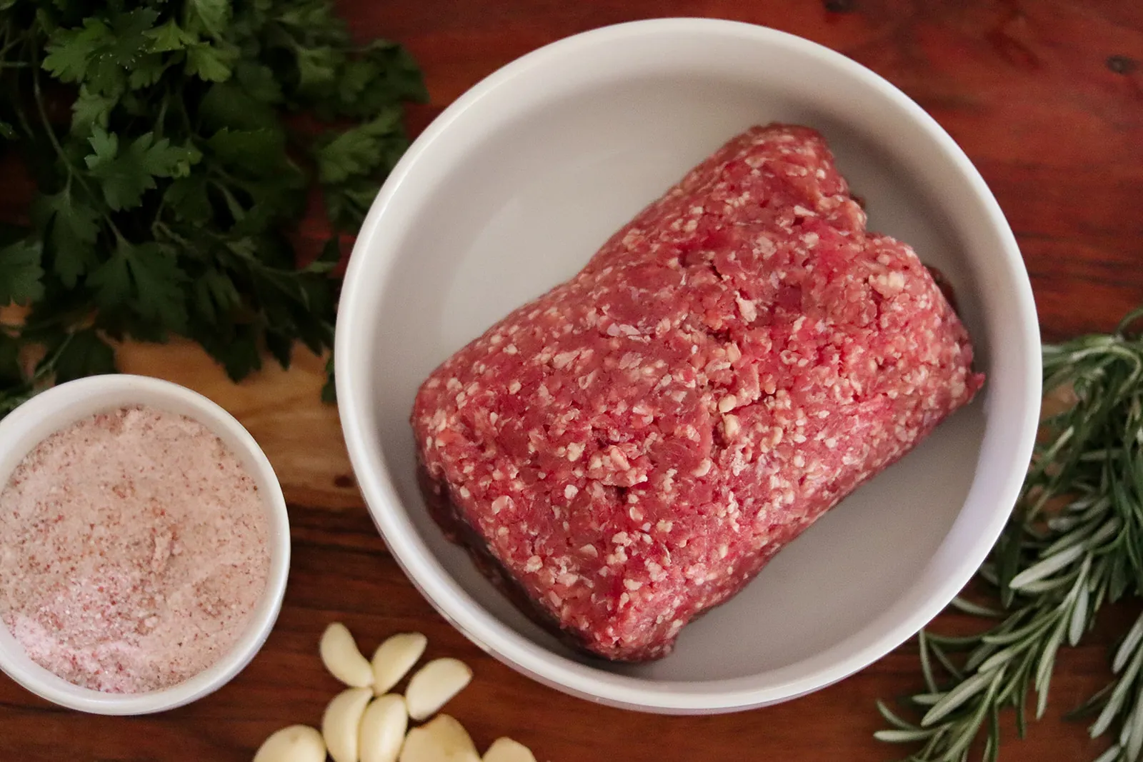 A bowl of fresh Barton Beef ground sirloin with herbs, garlic and pink salt
